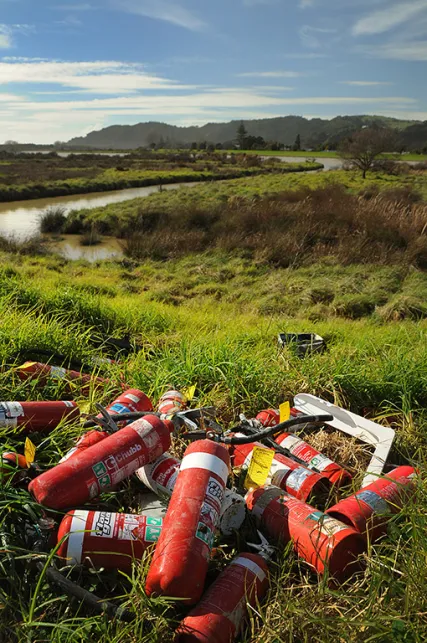 Abandoned fire extinguishers and other refuse near Keepa Road.